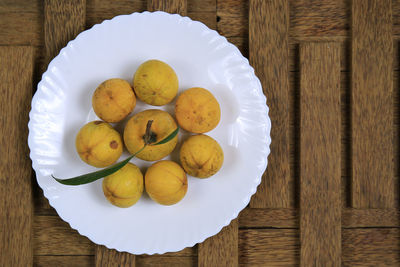 High angle view of fruits in plate on table
