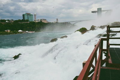 Scenic view of river flowing through city