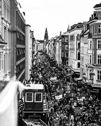 Traffic on street amidst buildings in city