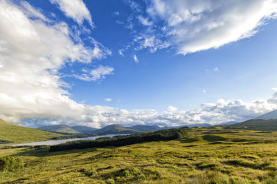 Scenic view of mountains against cloudy sky