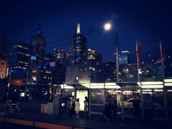 Illuminated cityscape against sky at night