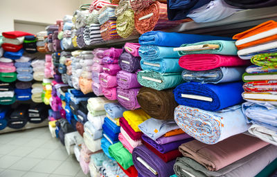 Close-up of various fabrics for sale at store