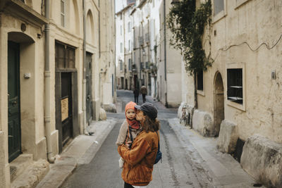 Mother with baby walking on street