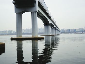 Bridge over river with city in background