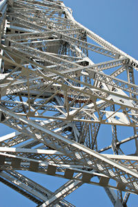 Low angle view of metallic structure against blue sky