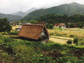 Scenic view of field and mountains against sky