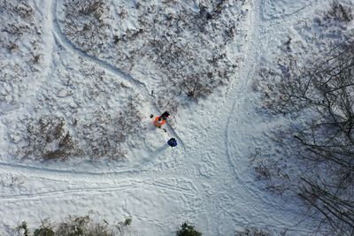 Aerial view of people standing on snow covered land