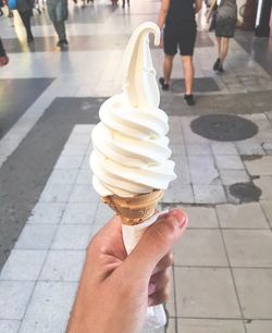 Cropped image of hand holding ice cream cone