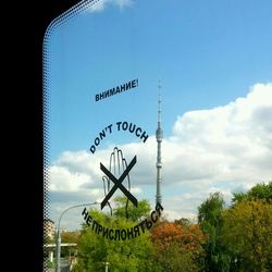 Low angle view of road sign against blue sky