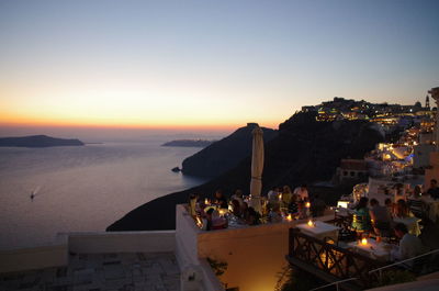 View of town at seaside during sunset