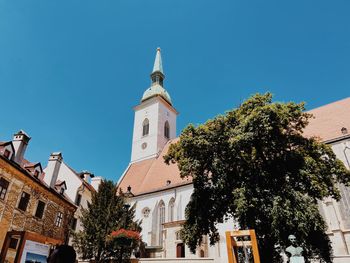 Low angle view of church against clear blue sky