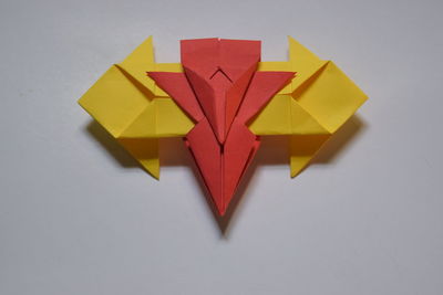 High angle view of yellow paper over white background