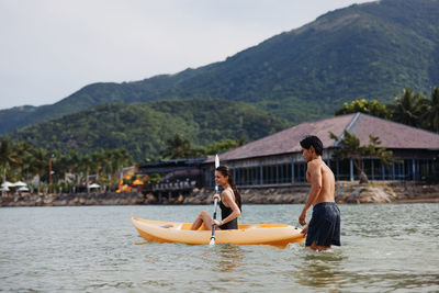 Man sitting in boat in sea