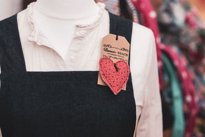 Close-up of heart shape with text on mannequin