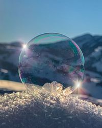 Close-up of bubbles against sky