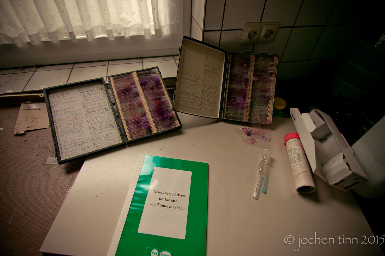 indoors, high angle view, table, book, text, communication, education, no people, paper, technology, day