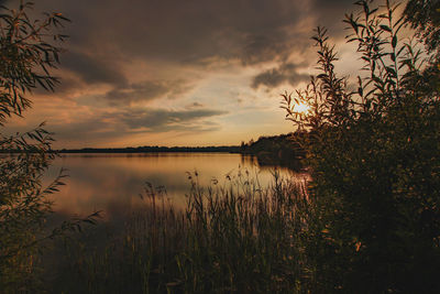 Scenic view of lake against sky during sunset