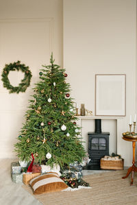 Cozy christmas interior of the living room with a fireplace and a christmas tree