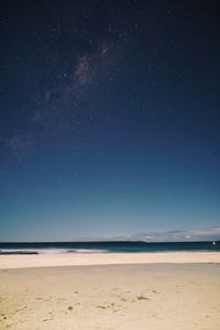 Scenic view of beach against sky at night