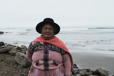 Full length of woman on beach against sky