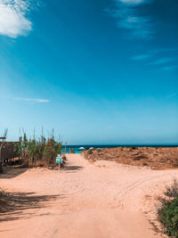 Scenic view of beach against blue sky