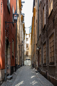 Narrow alley amidst residential buildings in gamla stan in stockholm