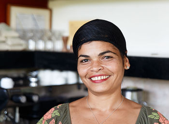 Portrait of smiling woman standing in restaurant