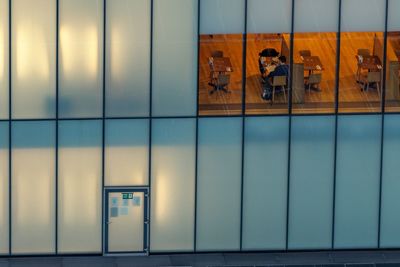 Reflection of people on glass window