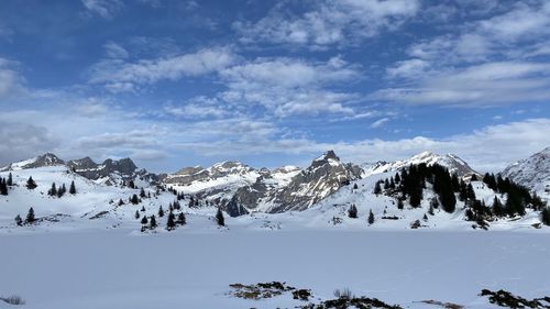 Scenic view of snowcapped mountains against sky