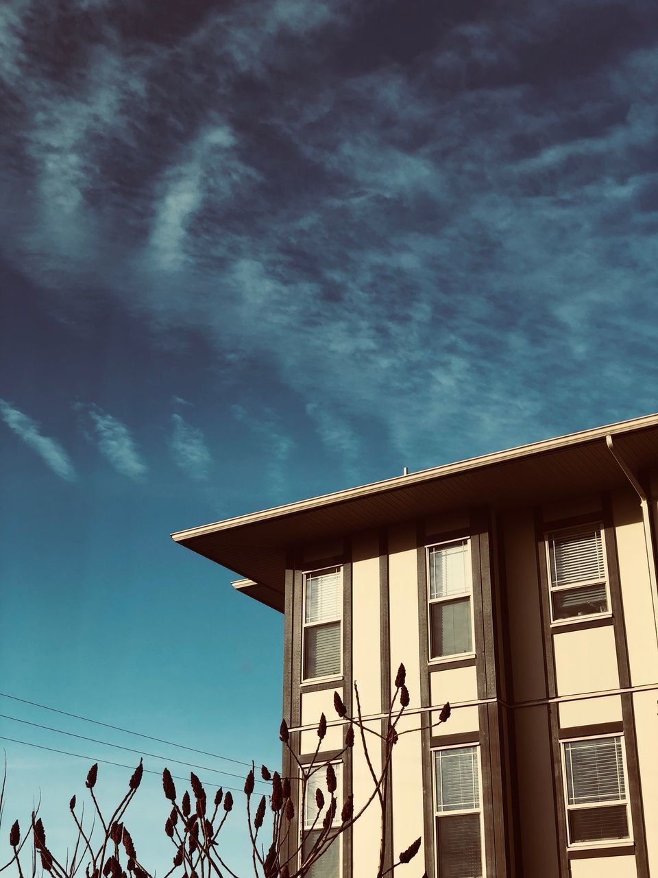 LOW ANGLE VIEW OF BUILDING AGAINST BLUE SKY