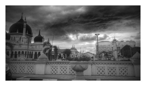 Facade of church against cloudy sky