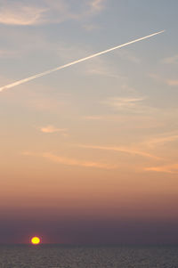 Scenic view of sea against romantic sky at sunset