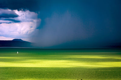 A storm is preparing on lake balaton. a small sailboat escapes from it. he didn't manipulate.