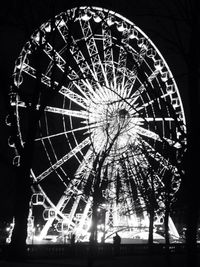 Low angle view of illuminated ferris wheel at night