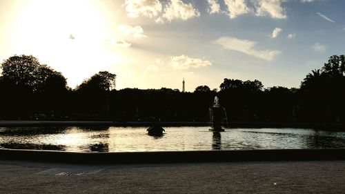 Silhouette of trees and calm lake