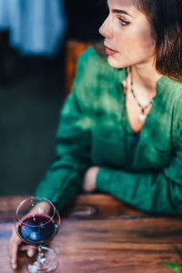 Young woman looking away while sitting at table