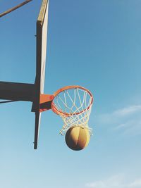 Low angle view of basketball hoop against blue sky