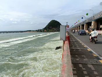View of city by sea against sky