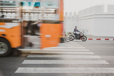 Man riding bicycle on road in city