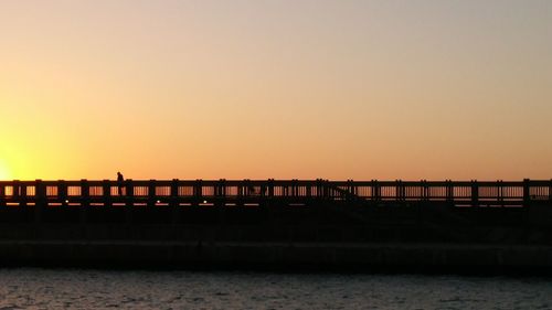 View of bridge against clear sky at sunset