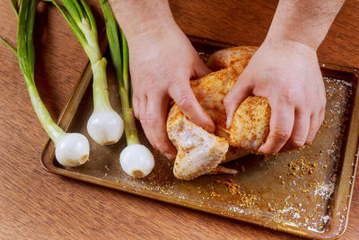 Cropped hands of man preparing food on table