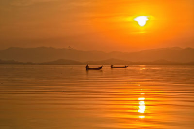 Scenic view of sea against orange sky