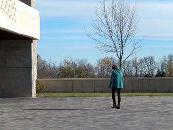 Full length of man walking on road against sky