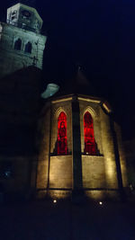 Low angle view of illuminated tower at night