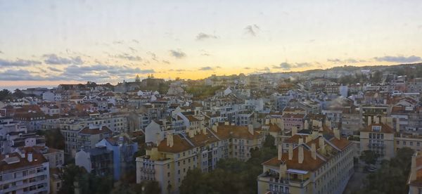 High angle shot of townscape against sky at sunset