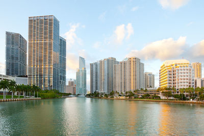 City by river against sky