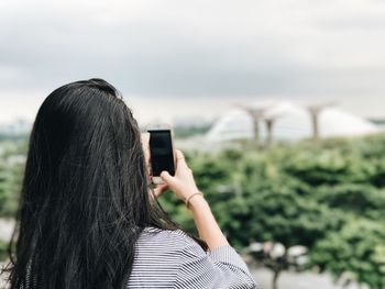 Rear view of woman photographing