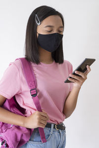 Midsection of man using mobile phone against white background