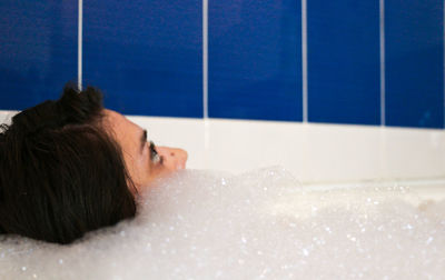 Close-up of woman relaxing in bathroom