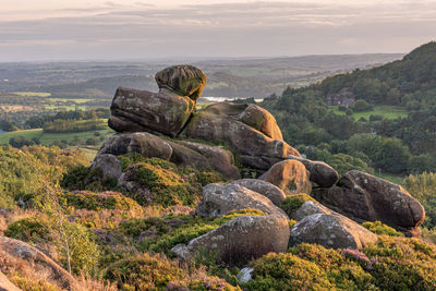 Rock formations on landscape against sky